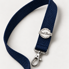Dad Built badge pin on a navy lanyard